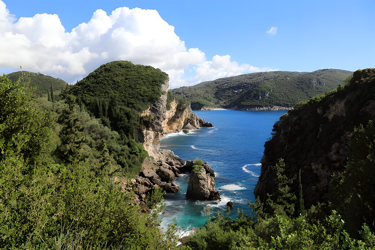 PDGIT9392130: Baia rocciosa tra verde e mare blu