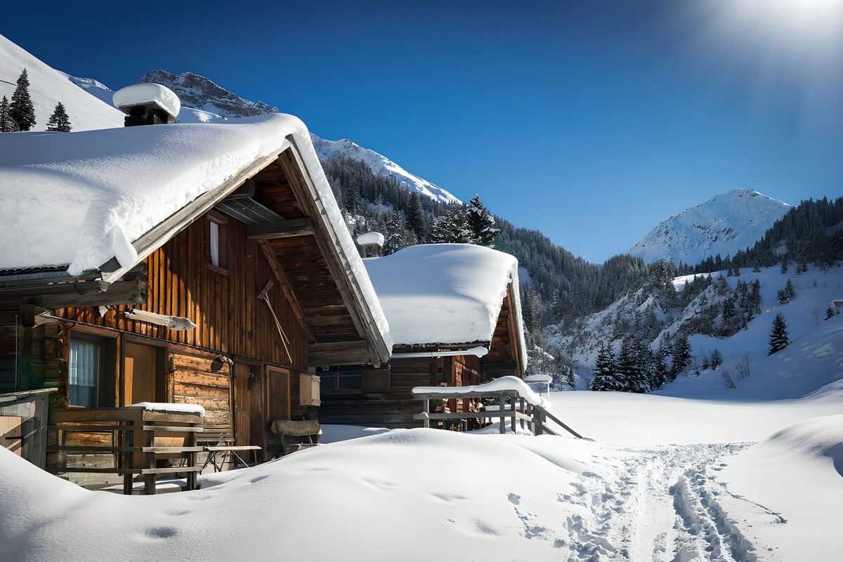 Chalet di legno nella neve al sole
