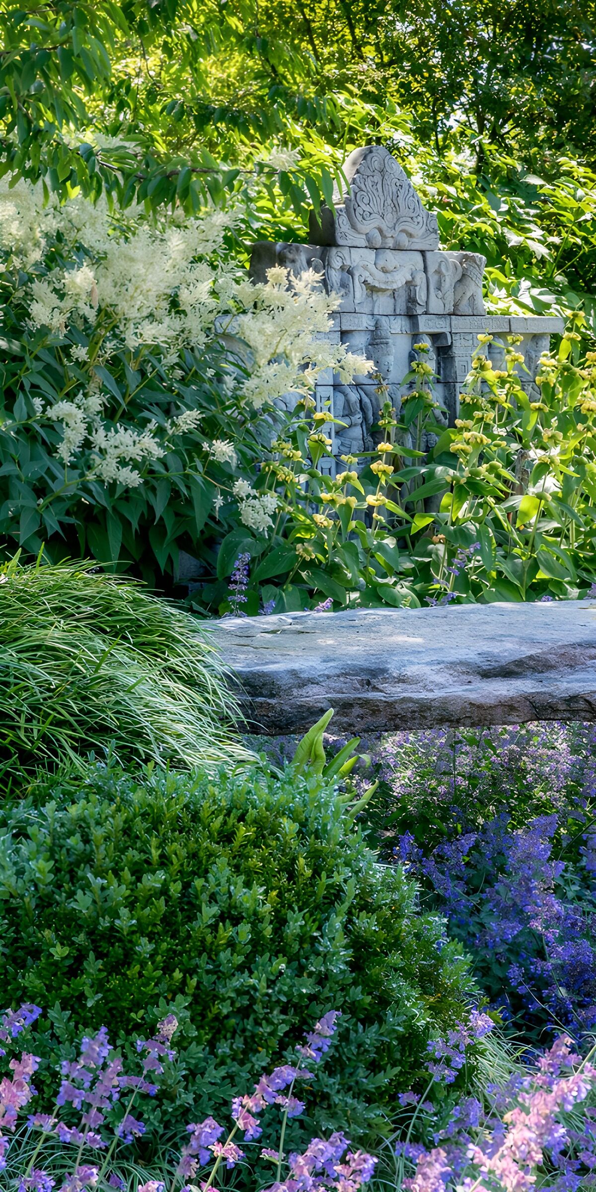 PDGIT1449533: Giardino fiorito con scultura in pietra