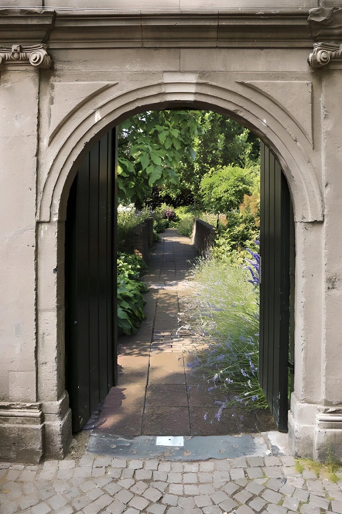 Arco in pietra sul giardino in fiore