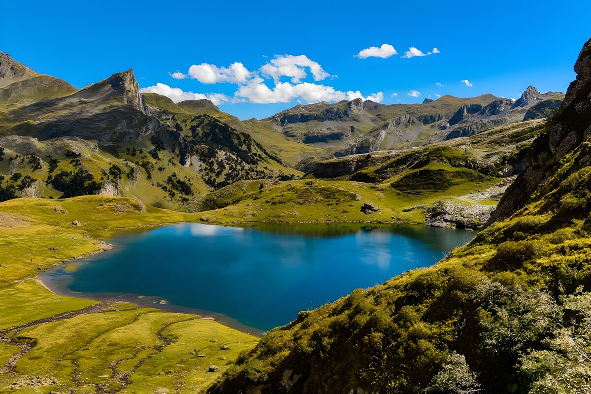 PDGIT4937978: Lago blu tra prati e cime al sole