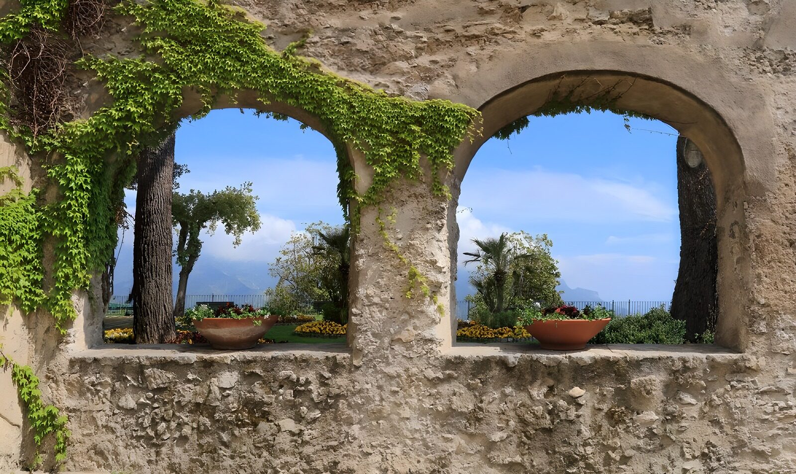 PDGIT6668984: Archi di pietra sul giardino in fiore